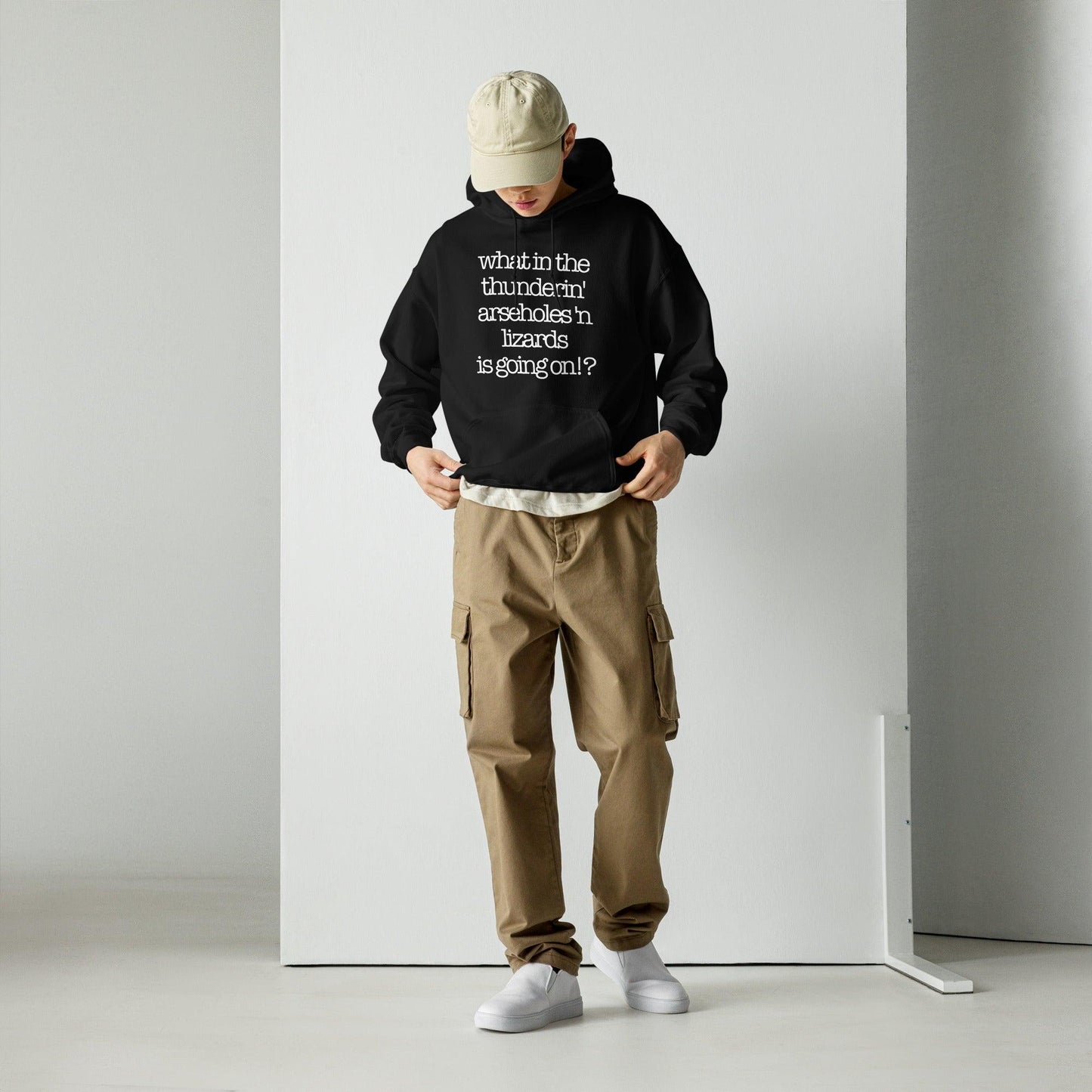 Person wearing "What in the Thunderin' Hoodie (The Bruce)" with bold text, paired with cargo pants and a cap.