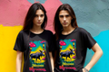 Moose Shrooms Nature T-Shirt featuring moose with colorful mushrooms, worn by two models against a vibrant mural.