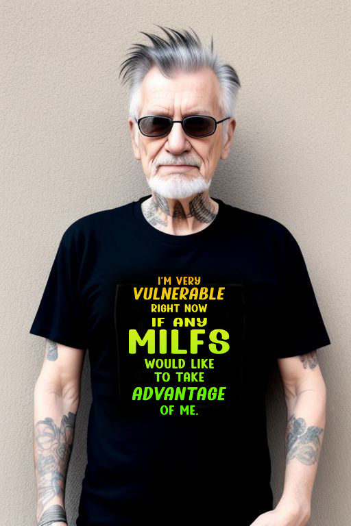 Man wearing black "Searching for a MILF Tee" with humorous text, sunglasses, and tattoos.
